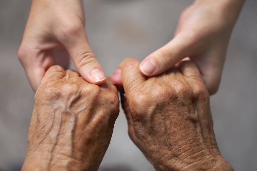 Two pairs of hand holding each other