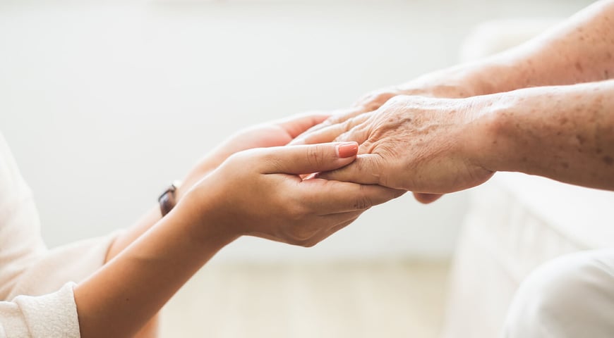 Two pairs of hands holding each other