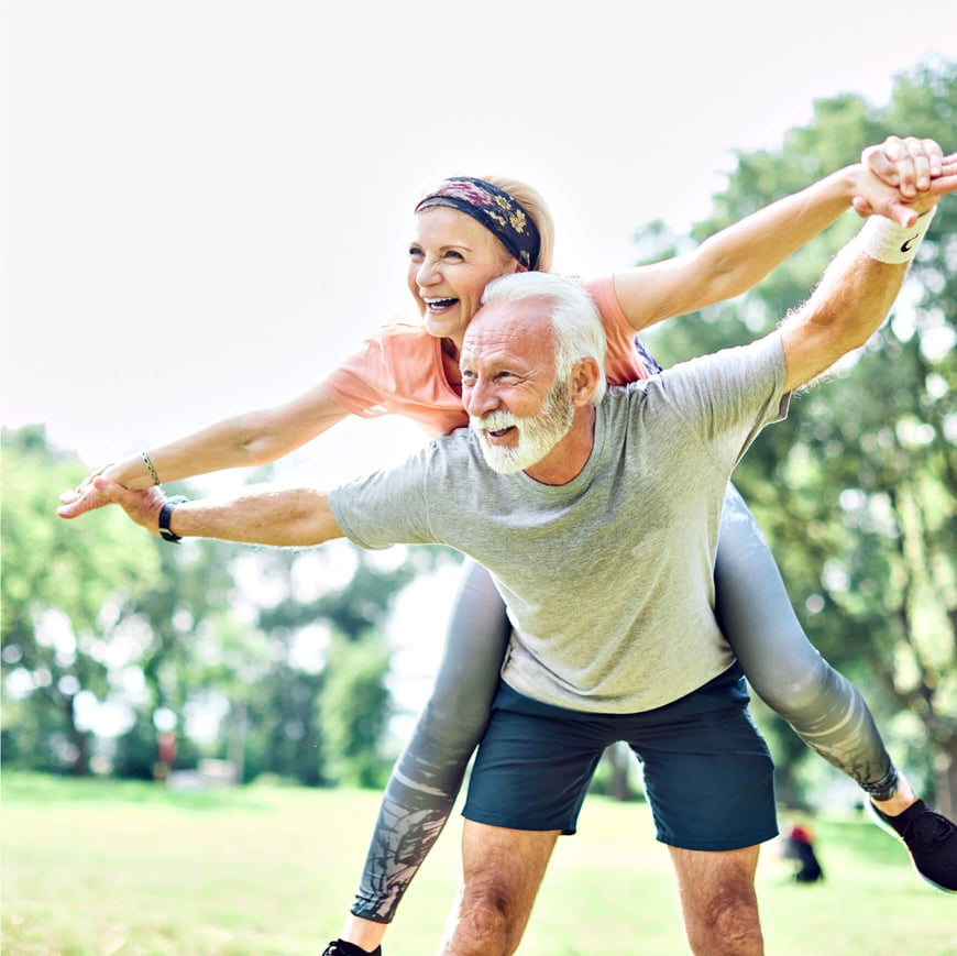 Older woman and man enjoying exercise in the park
