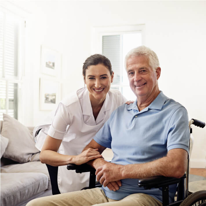 Home health nurse and male patient smiling looking at the camera